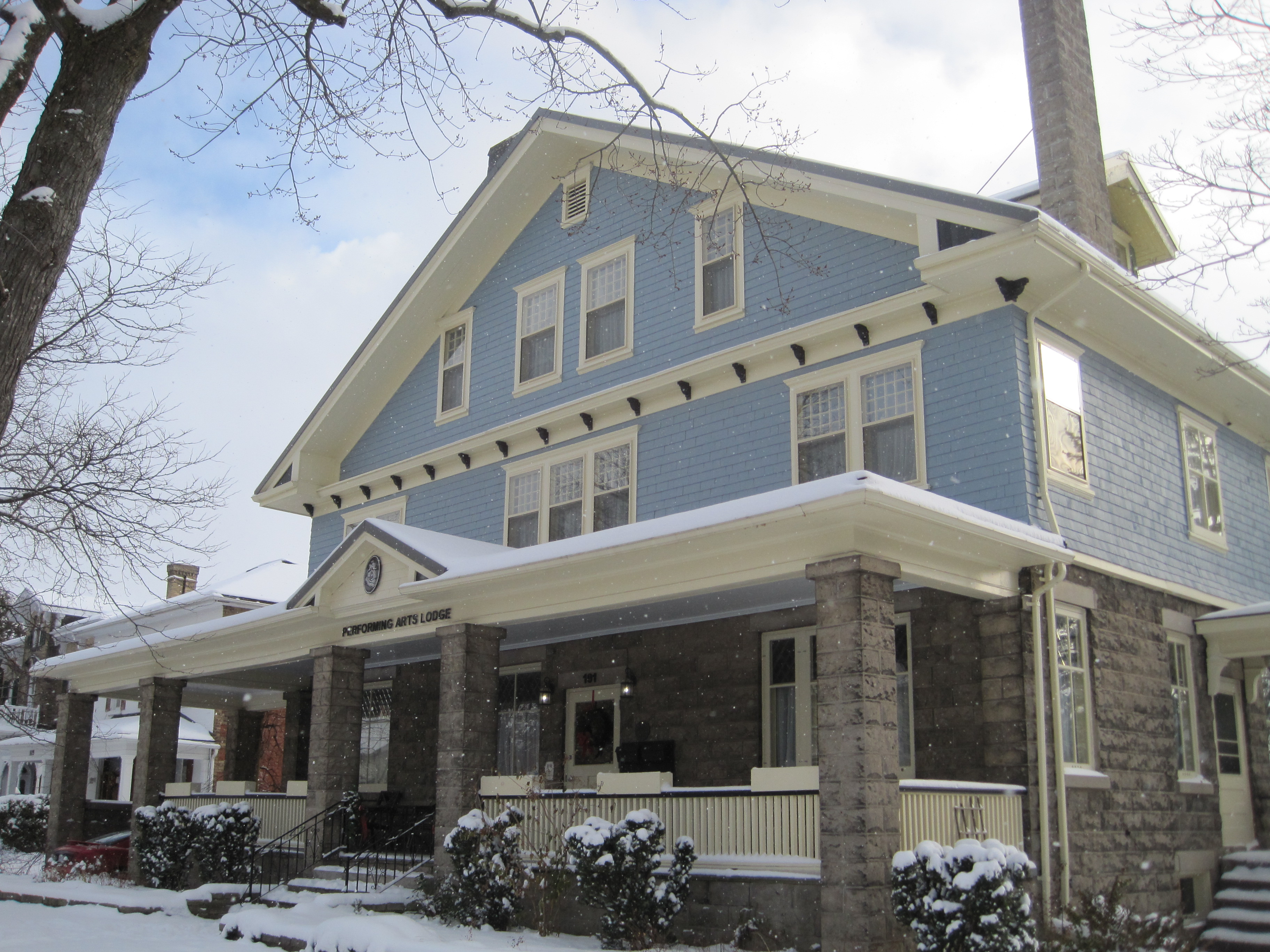 Painted blue and grey brick Craftsman style home