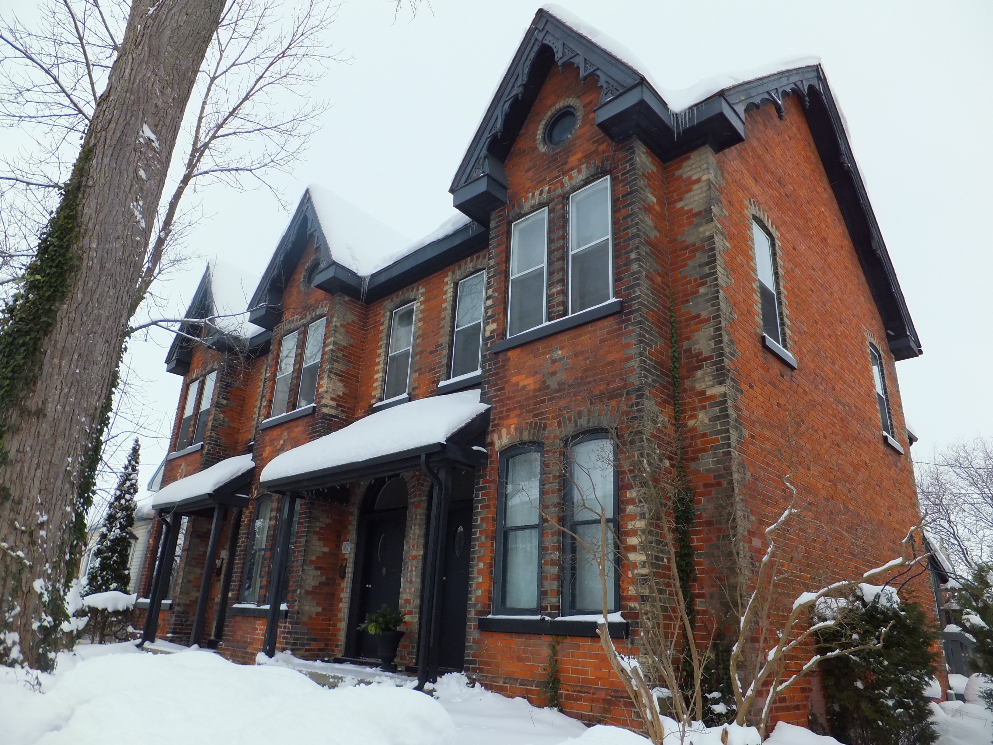 Red brick with yellow brick accents Italianate with Gothic Revival features style house