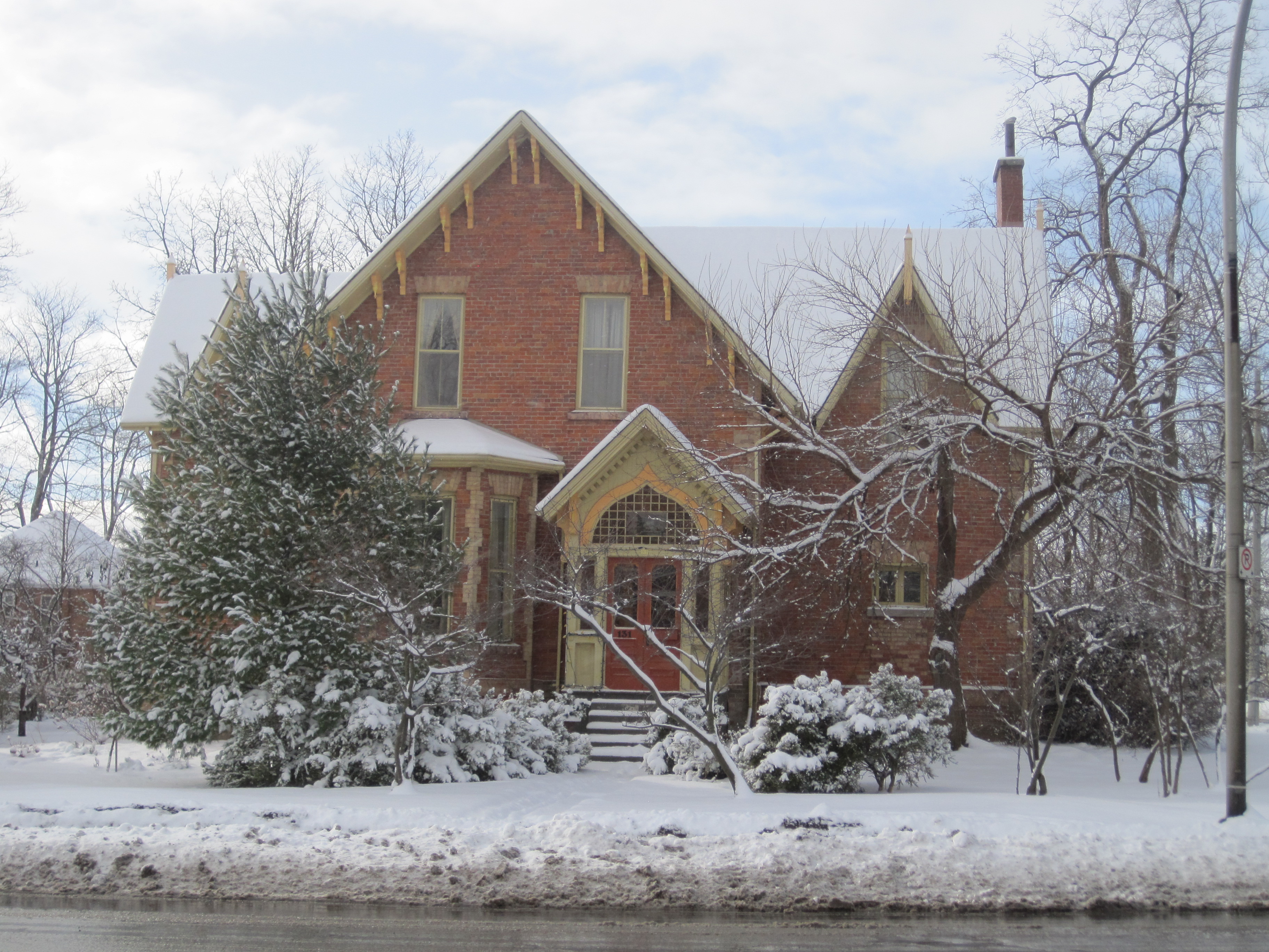 Red brick with yellow brick trim Gothic Revival style house