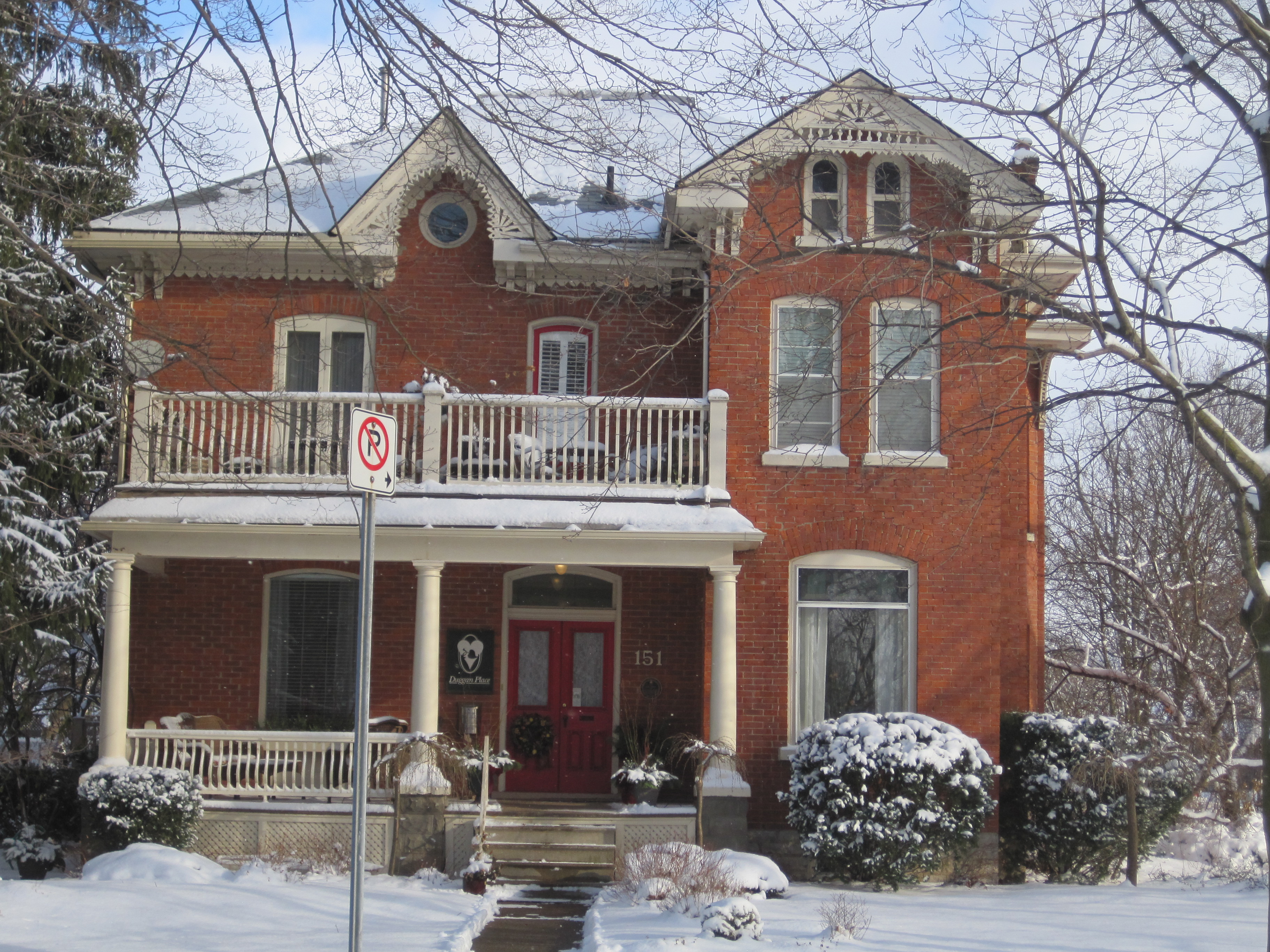 Red brick Italianate with Queen Anne Elements style house