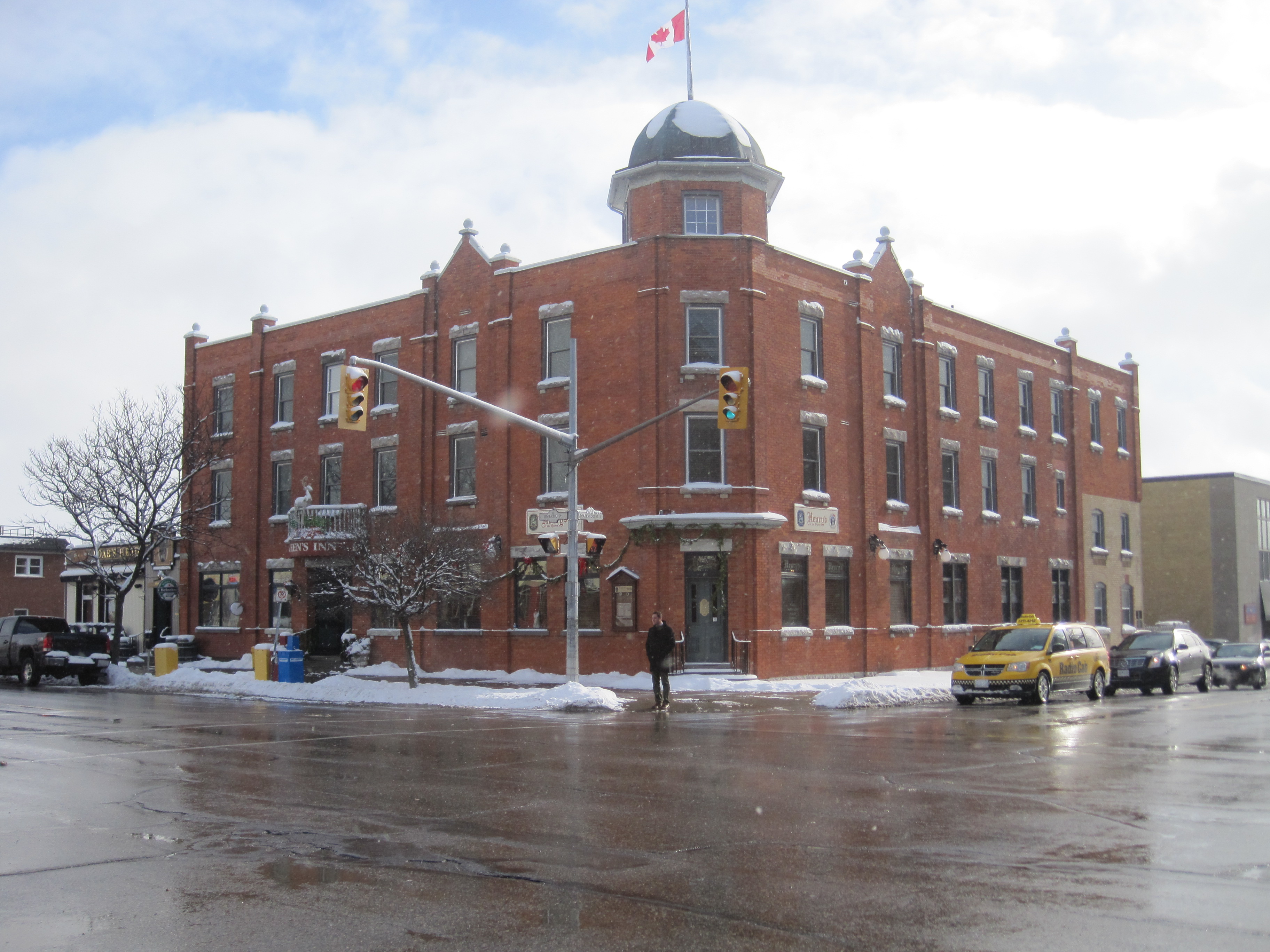 Three storey red brick Queen Anne style building