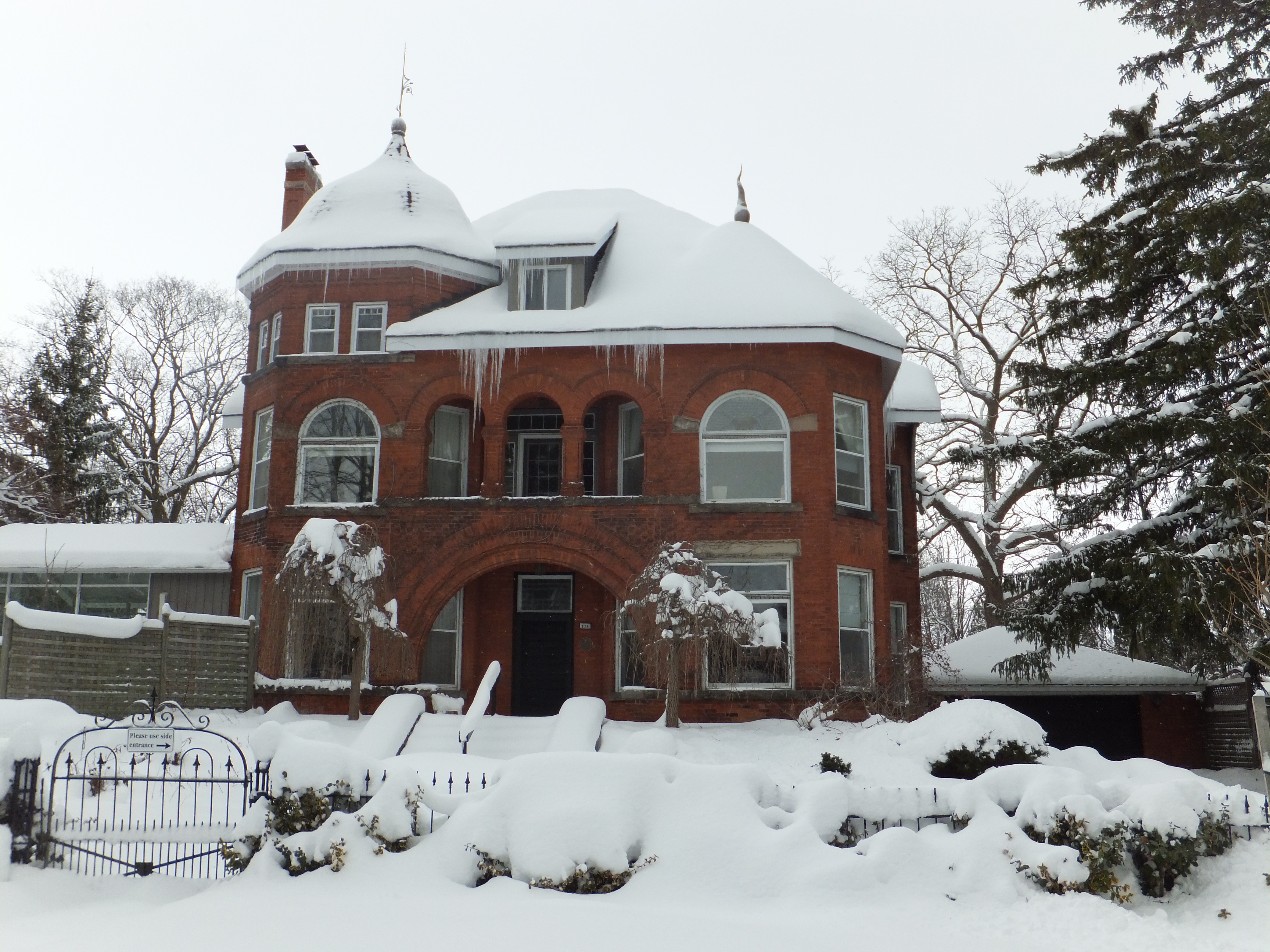 Red brick Romanesque Revival/Queen Anne style house