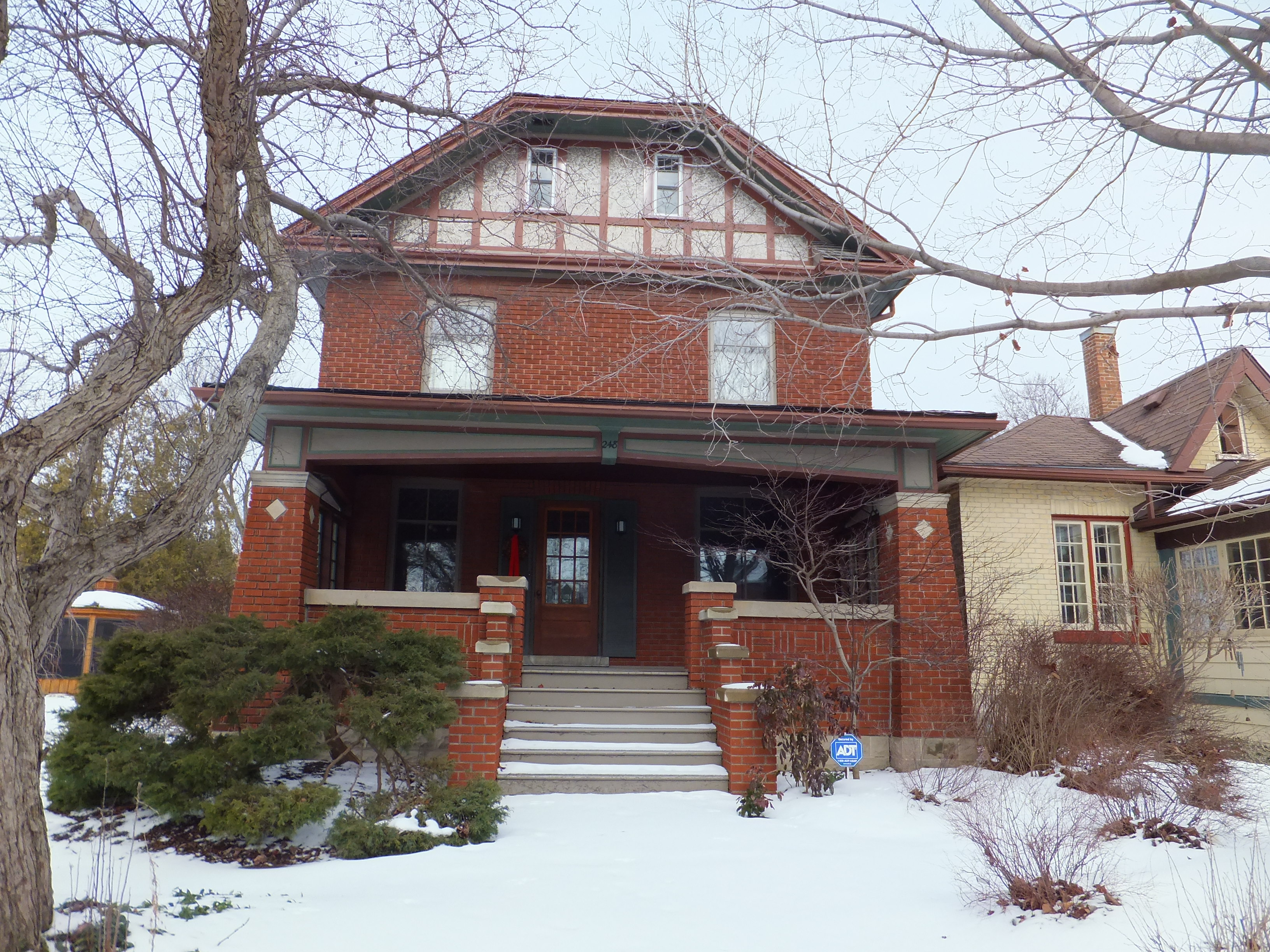 Red brick Craftsman and Prairie style house