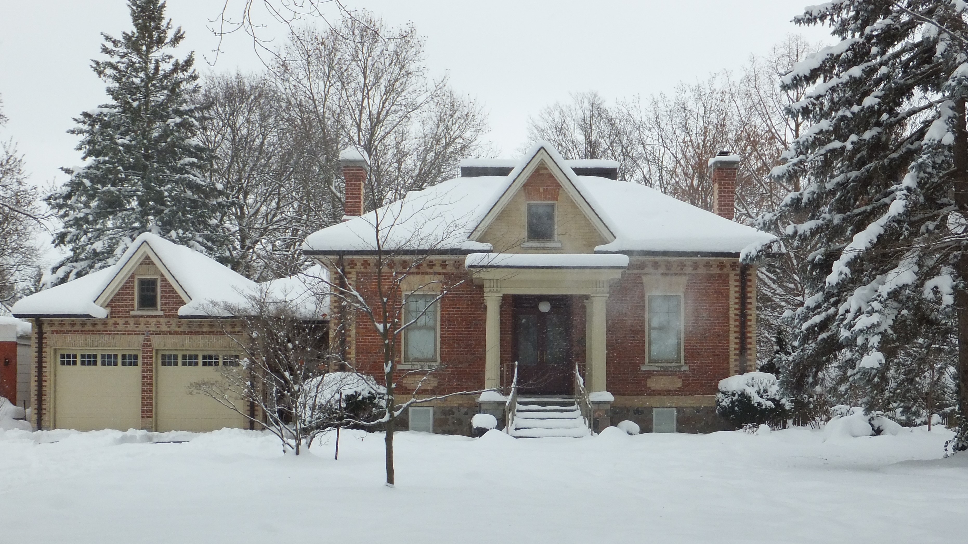 Red brick with yellow brick accents Ontario Cottage style house