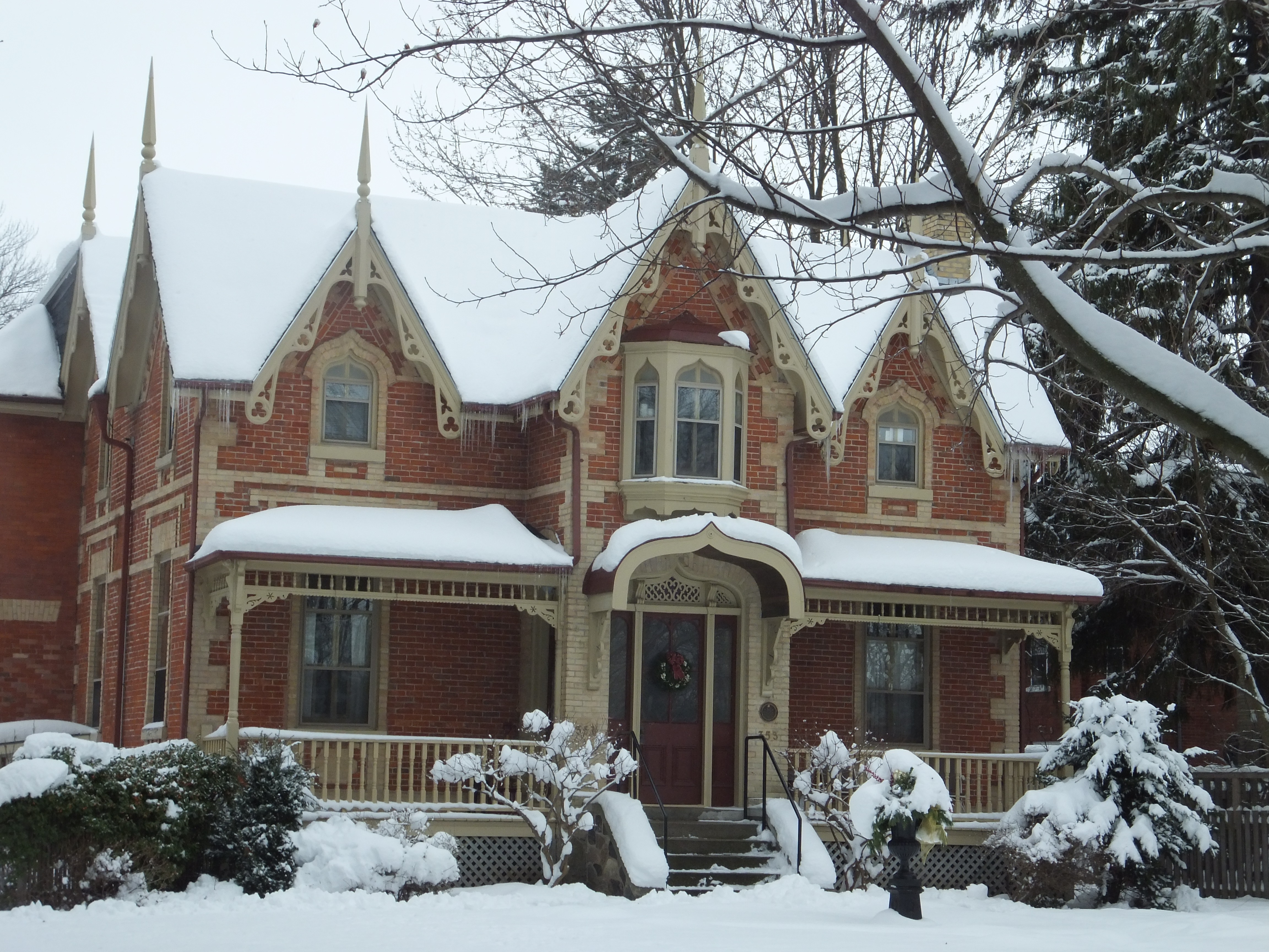 Red brick with yellow brick accents Gothic Revival style house