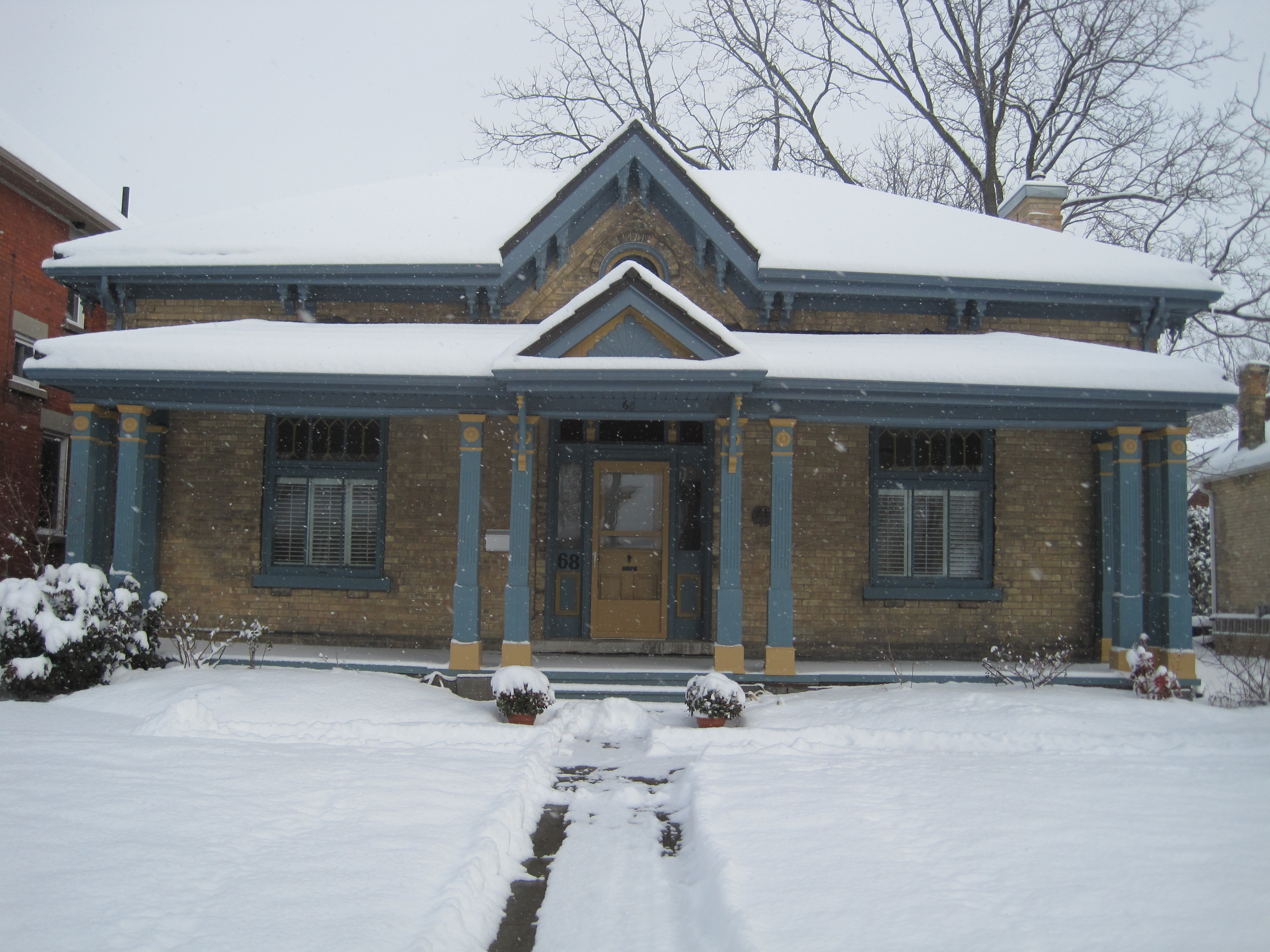 Yellow brick Regency Ontario Cottage style house