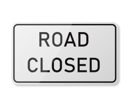 White sign with ROAD CLOSED